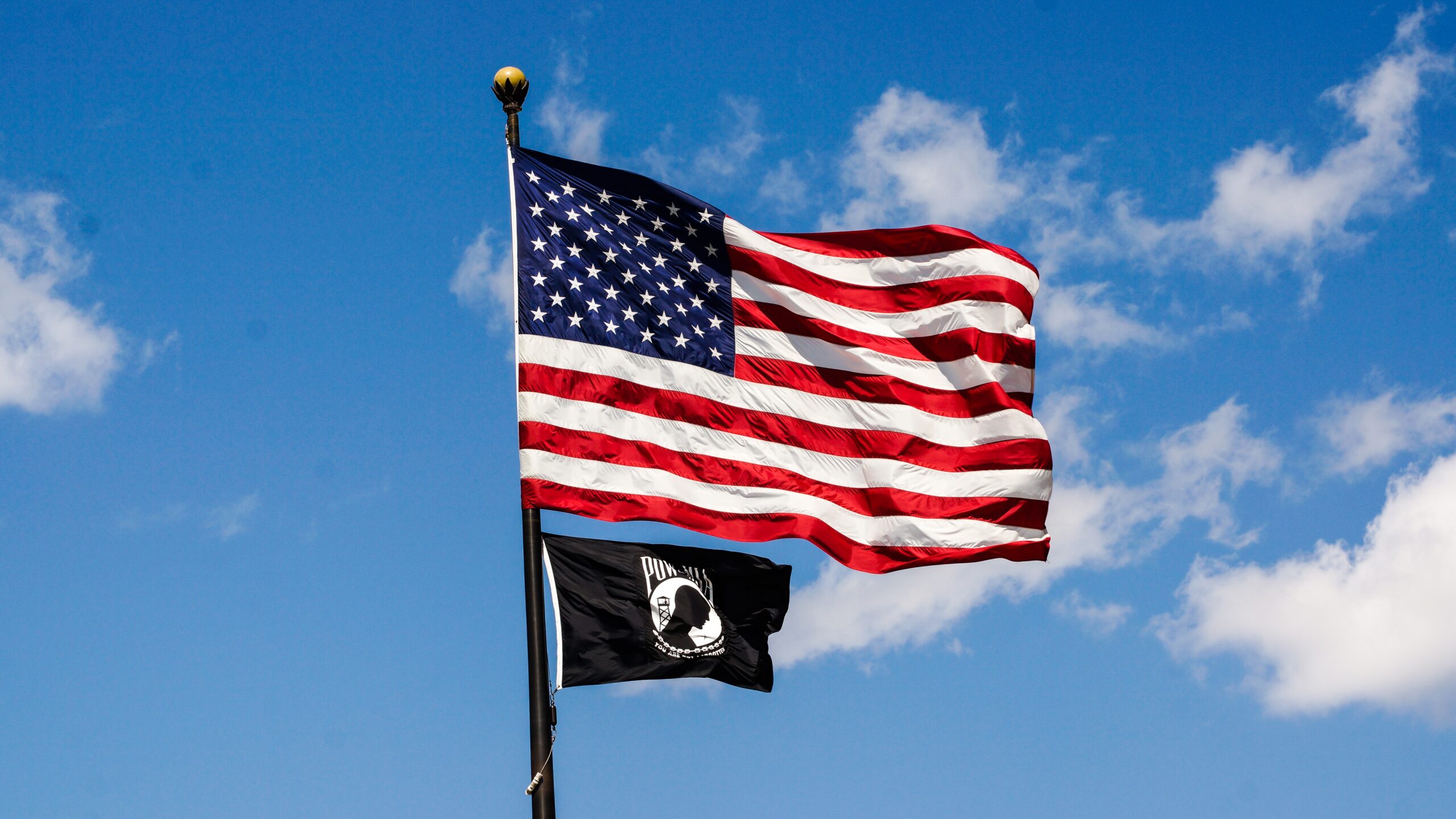 What is the black flag under the American flag?