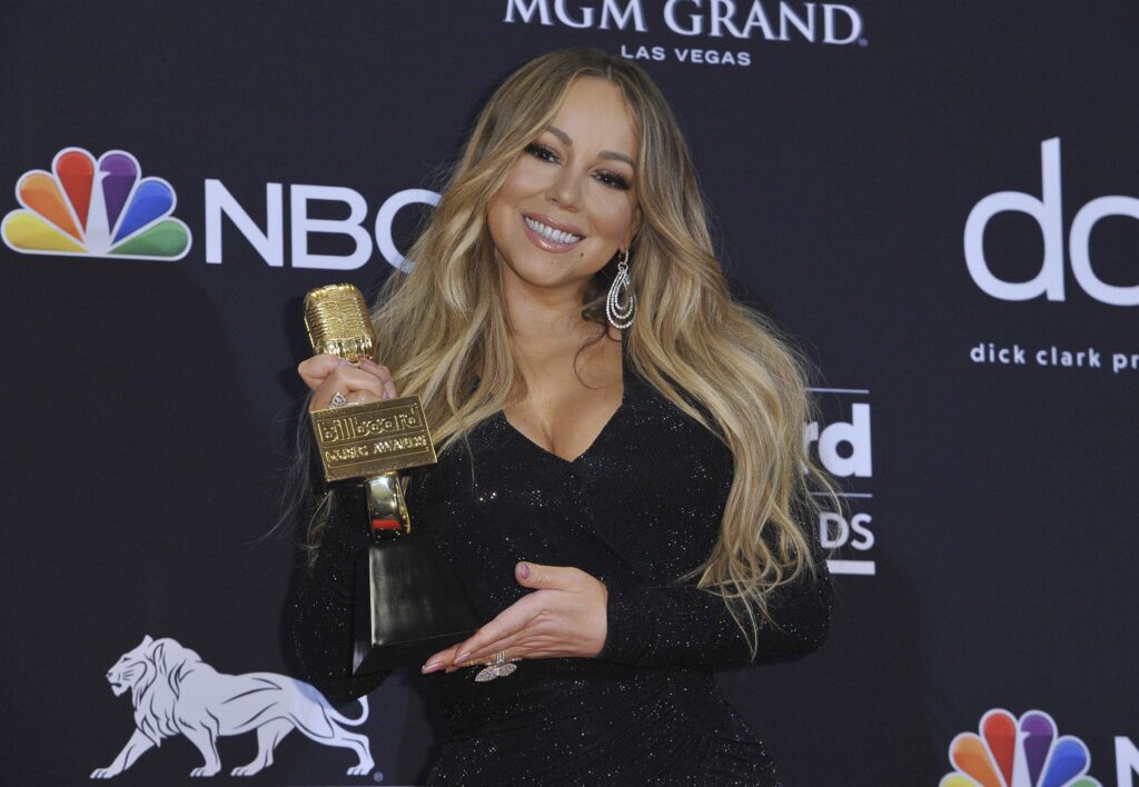 Who has passed Mariah Carey in records?